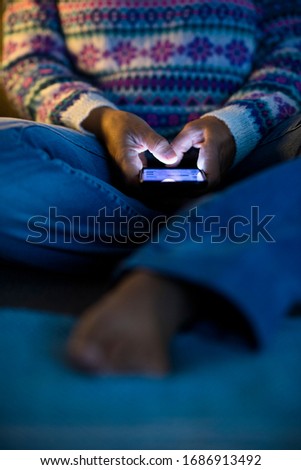 Close up of people hands and internet device phone by night - screen light and unreconizable woman for technology addiction - stay home coronavirus concept
