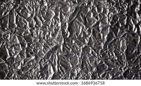 Aluminum crumpled foil, Pattern background with high-resolution design for book cover or brochure, poster, wallpaper or realistic business. Silver texture background, polished metal steel