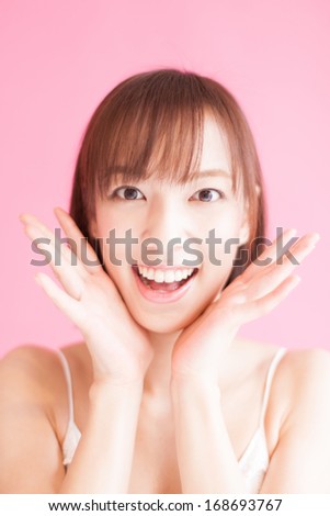 happy young woman against pink background 