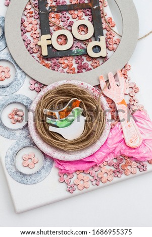 Canvas of overlapping objects glued to the collage style. Conceptual photo of a bird's nest as a food dish. Mix media crafts.