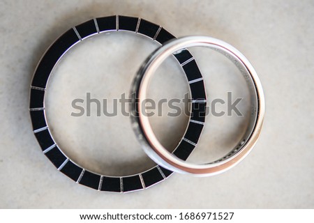 Two designer golden wedding rings with copy space and selective focus. Close-up view of white golden wedding rings in a box, before wedding ceremony and vows. Macro. 