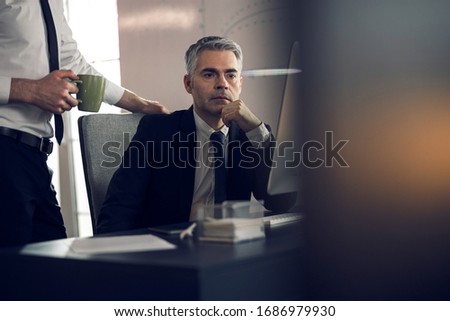 Boss and his young assistant working at computer stock photo. Business concept