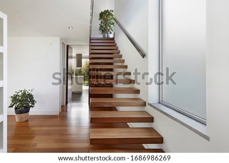 Apartment entrance hall with wooden staircase access to upper floor, design, furniture, home, modern, sea, wooden Royalty-Free Stock Photo #1686986269
