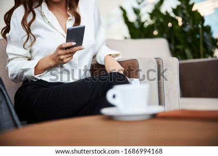 Close up of elegant lady texting message on smartphone stock photo
