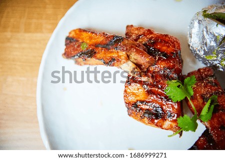 Grilled ribs on a wooden table.