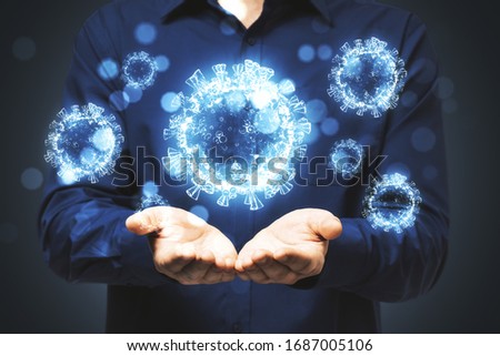 Man holds in his hands blue virus cells. Concept of coronavirus. Healthcare and immunology. Royalty-Free Stock Photo #1687005106