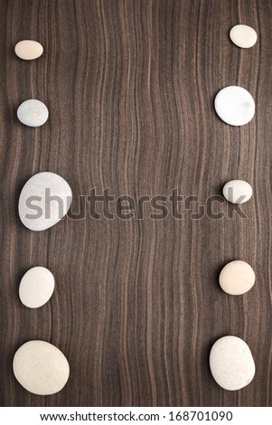 pebbles on ebony wood texture