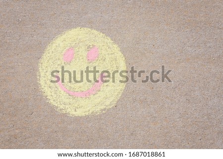 Yellow smiling face made with sidewalk with copy space