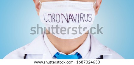 Doctor wearing protection face mask against coronavirus on light blue background.Banner panorama medical staff preventive gear.