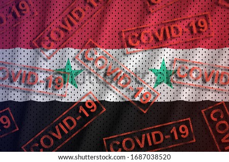 Syria flag and many red Covid-19 stamps. Coronavirus or 2019-nCov virus concept