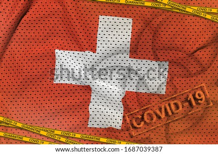 Switzerland flag and Covid-19 biohazard symbol with quarantine orange tape and stamp. Coronavirus or 2019-nCov virus concept