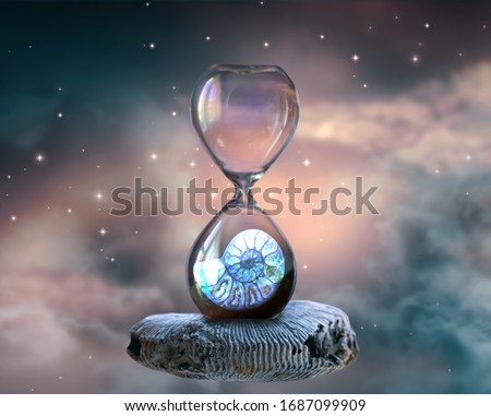 Hourglass hovering in space with ammonite fossil inside clock standing on petrified mollusc against cloudy sky and shining stars. Symbol of eternity, extinction and evolution, time is over concept. Royalty-Free Stock Photo #1687099909