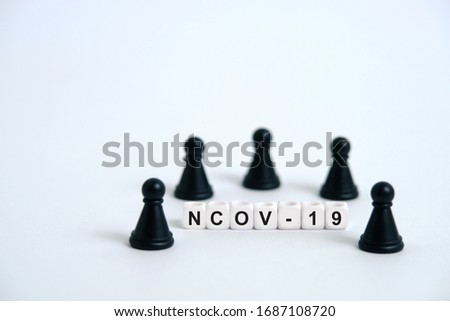 Pandemic coronavirus conceptual photography – stop spreading of COVID19 - word beads surrounded by chess pieces