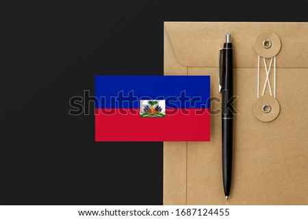 Haiti flag on craft envelope letter and black pen background. National invitation concept. Invitation for education theme.