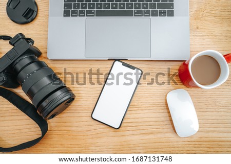 professinal photography equipment and electronic accessories on a wooden backgraund.