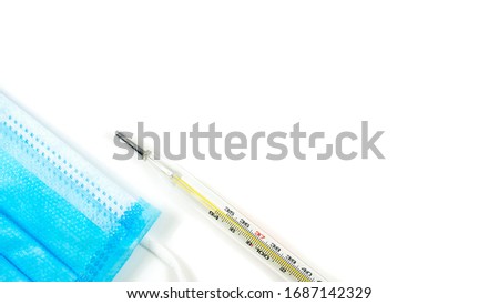 Glass bulb for mercury thermometer Placed near the blue mask The picture shows the lower-left corner. It is on a white background. There is a copy space taken from the top corner.