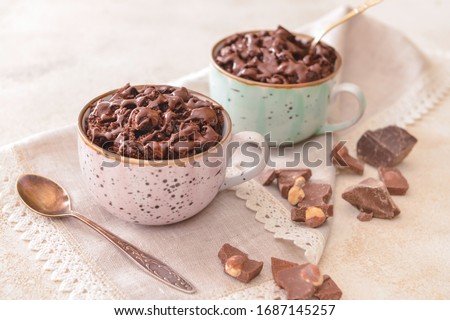 Chocolate mug cakes on table Royalty-Free Stock Photo #1687145257