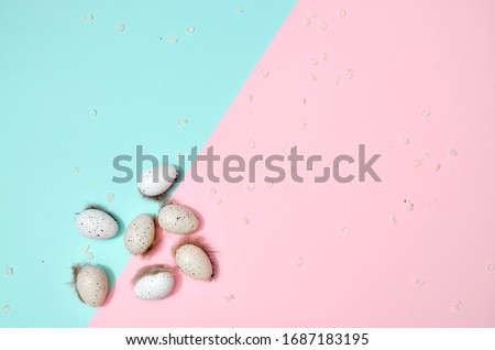 Many colorful easter eggs with spots on pink blue background. Design for your easter holidays card, space for text