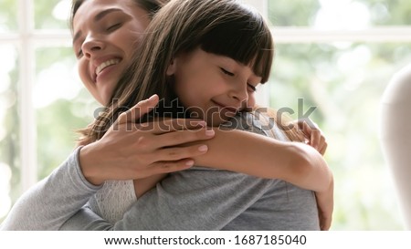 Cute little girl child embrace happy young mother show gratitude and love, caring happy smiling mom hug small preschooler daughter make peace reconcile after fight, family bonding, unity concept Royalty-Free Stock Photo #1687185040