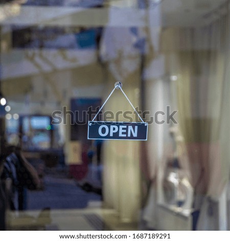 sign open on glass door of shop