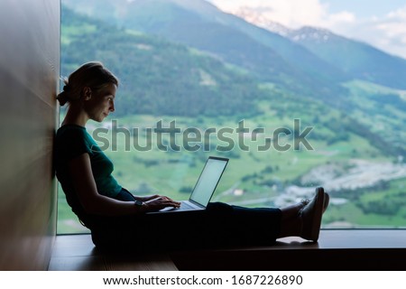 Skilled Caucasian female IT professional checking notification for laptop system connected to 4g internet, woman freelancer doing remote teleworking for banking via netbook app during vacations