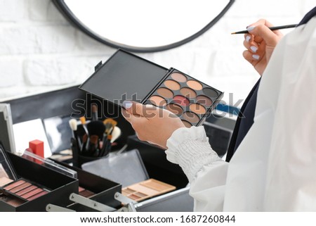 Makeup artist at workplace in beauty salon, closeup