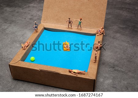 miniature people in a swimming pool.