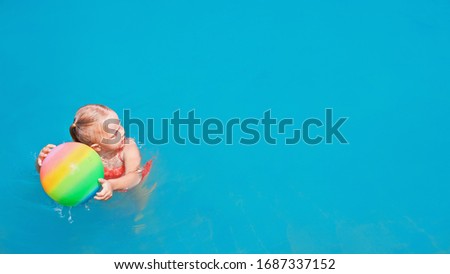 Happy girl have fun on summer beach holiday. Funny baby girl playing with ball. Aquatic game in swimming pool, top view. 