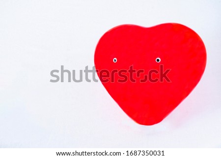 red heart with eyes on white background