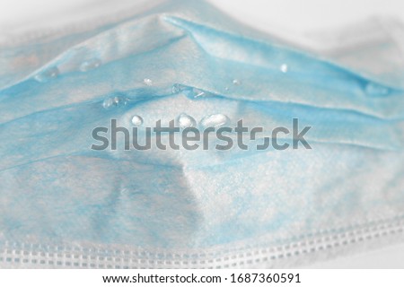 close up water drops on outer layer surgical face mask, Corona virus prevention