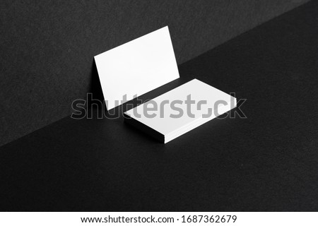 White businesscards on black background close up, copy space Royalty-Free Stock Photo #1687362679