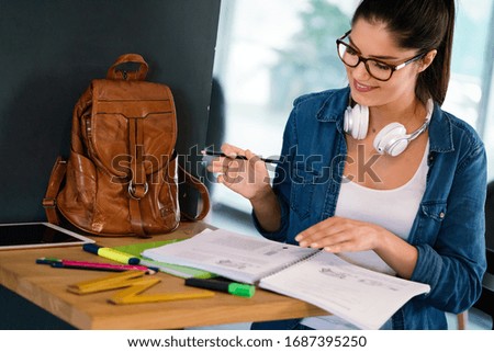 Pretty young college student studying, preparing for exam
