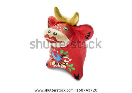 Ceramic souvenir statuette of red cow on white background