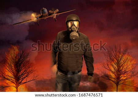 A man with a gas mask runs through a burning landscape in the background an aircraft with a burning engine can be seen