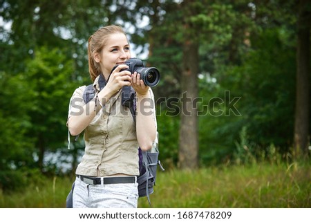 young woman with camera outdoor