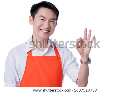 young smart attractive asian male restuarant owner hand sign ok gesture hand order online from home concept asian apron uniform smile warmw welcome for appllication order with free copyspace