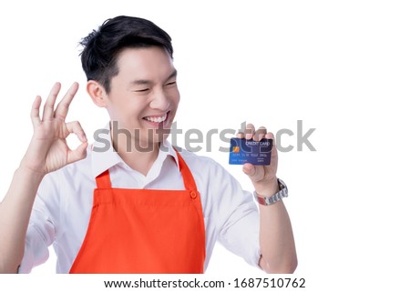 young smart attractive asian male restuarant owner hand sign ok with credit card online purchase order online from home concept asian apron uniform smile warmw welcome for appllication order isolate