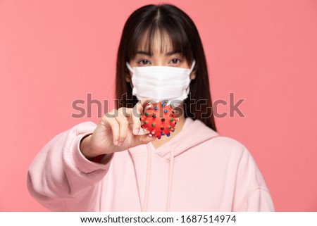young asian woman wearing protection mask or surgical mask for protected virus and air pollution making hand stop and hold virus on hand on pink background,Health care and coronavirus concept