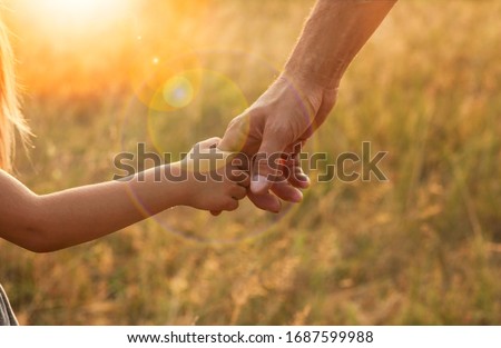 the parent holds the hand of a small child Royalty-Free Stock Photo #1687599988
