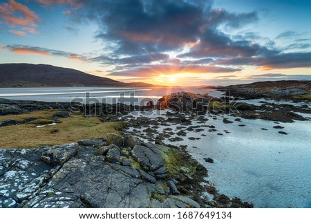 Beautiful sunset over the sandy beach at Luskentyre on the west coast of the Isle of Harris in the Outer Hebrides of Scotland Royalty-Free Stock Photo #1687649134