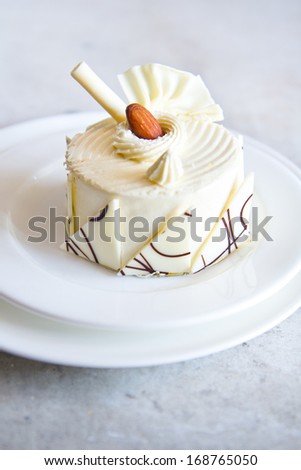 white chocolate cake with almond on top Royalty-Free Stock Photo #168765050