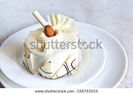 white chocolate cake with almond on top Royalty-Free Stock Photo #168765056