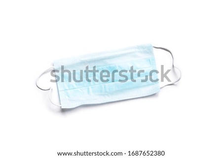Blue disposable earloop face mask isolated on a white background. Coronavirus protection