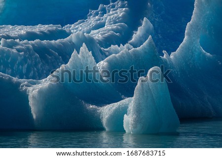 blue iceberg in glacier lagoon close up razor edge  Royalty-Free Stock Photo #1687683715