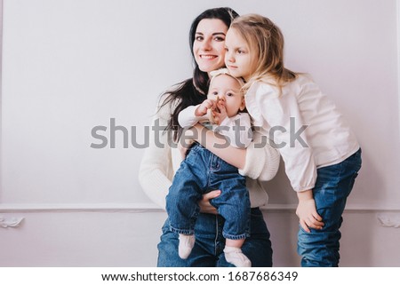 Mother and child . Mom and baby girl playing in sunny room. Mother and child girl playing, kissing and hugging.