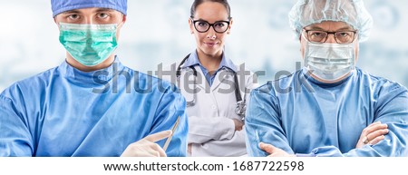 Frontline medics team with and without various face masks facing pandemic. Arms crossed male and female doctors in protective gear fighting coronavirus COVID-19. Royalty-Free Stock Photo #1687722598