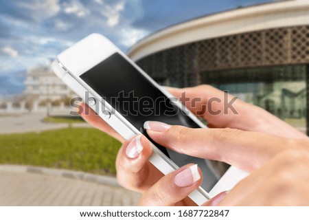 Human hand using a mobile phone with an empty screen