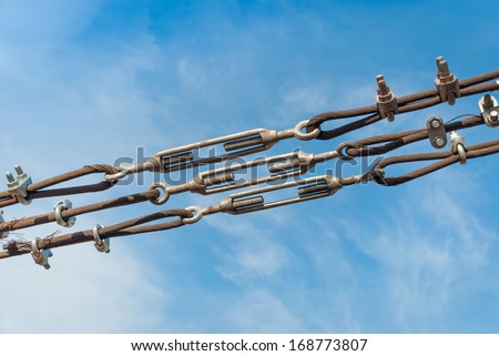 close up steel turnbuckle and sling steel in construction site on a blue sky background