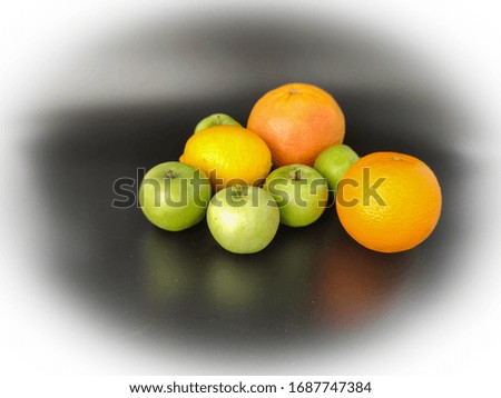 Whole fruits green apples, orange, grapefruit and lemon on black background. Concept - vegetarian and healthy food to improve the immunity Stock photo.