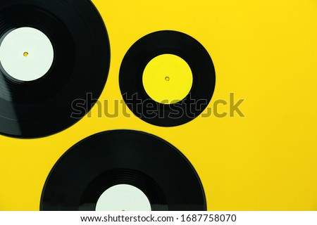 Table Top view of musical instrument retro concept.Flat lay objects of the many music disk on modern rustic yellow paper at home office desk.copy space for creative design text and word.